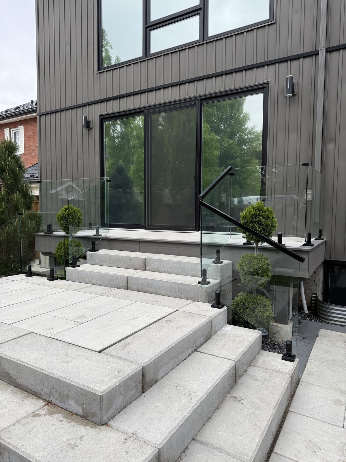 Frameless glass railing on modern home exterior